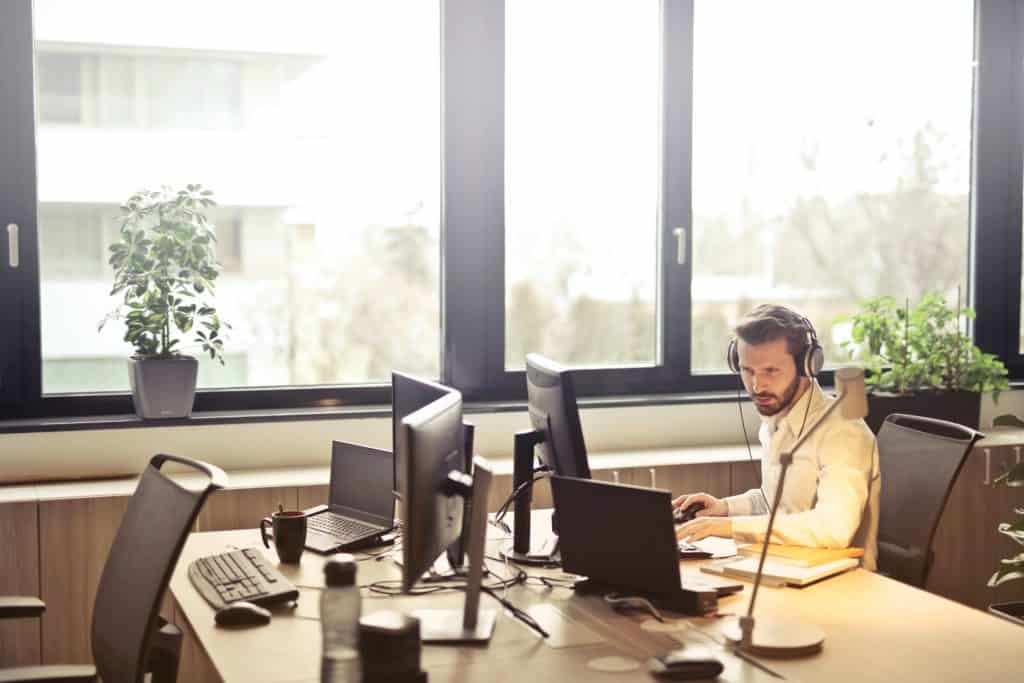 male office worker at computer in conference room